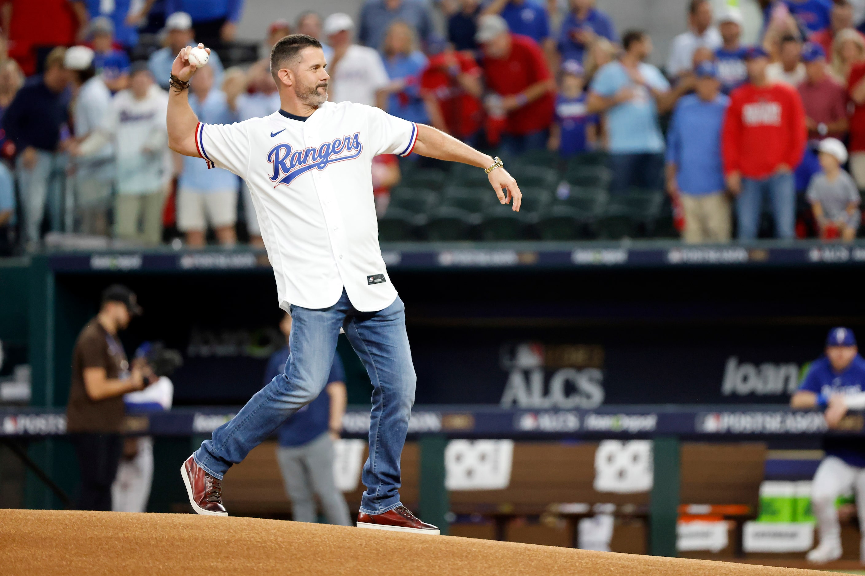 Former Texas Rangers infielder Michael Young throws out the ceremonial first pitch before...