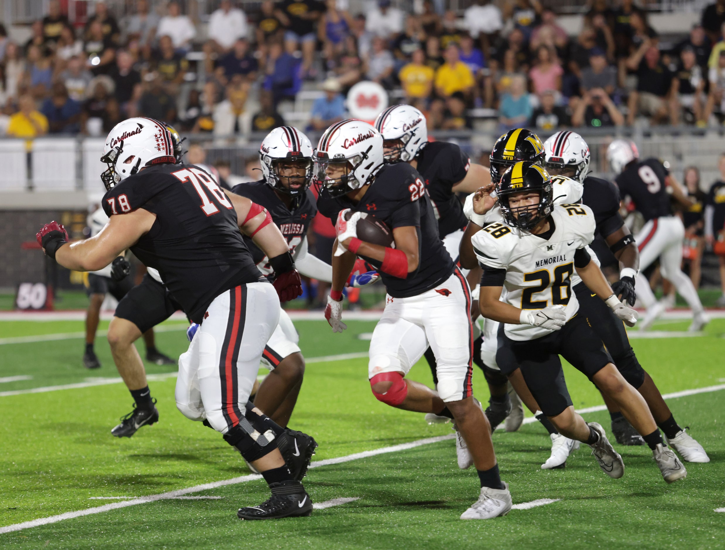 Melissa player #22 Jeremiah Tabor gets behind player #78 Owen Hollenbeck for cover as he...