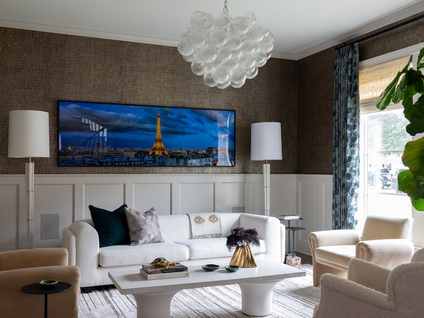 Living room with white paneling along the walls, brown wall covering above paneling