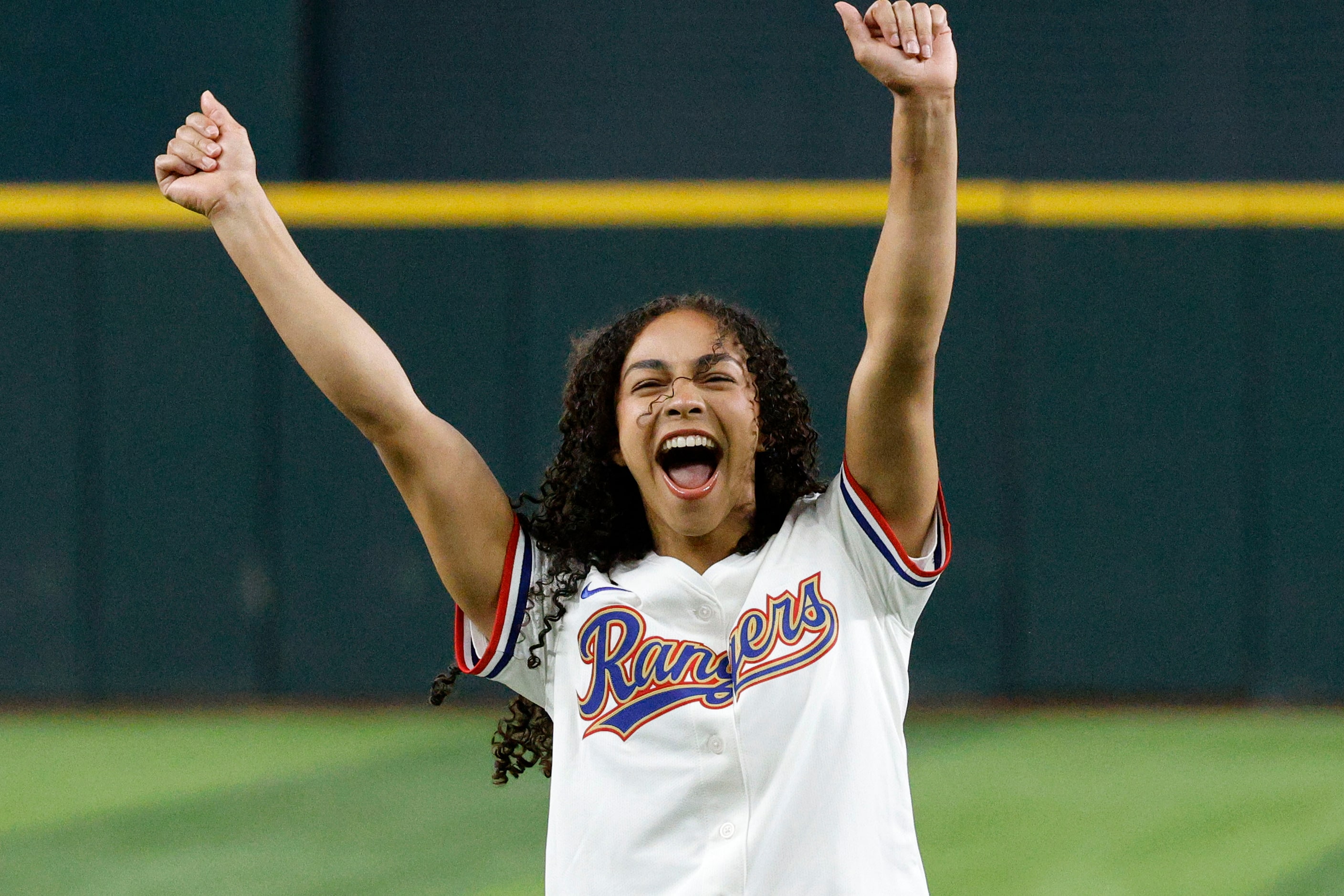 Olympic Gold medalist Hezly Rivera from Plano reacts after throwing out a ceremonial first...