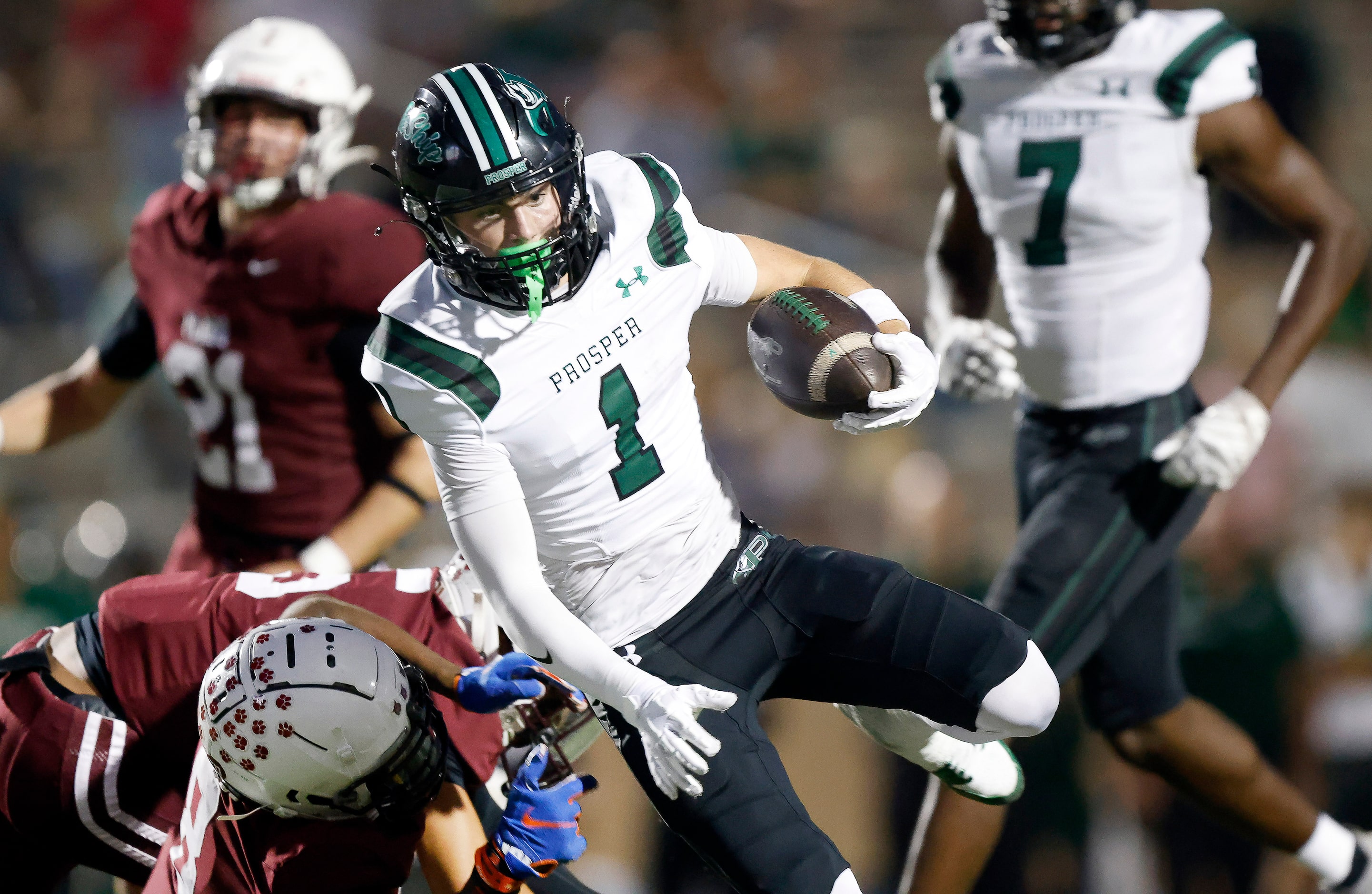 Prosper High’s Lathon Latiolais (1) shakes a tackle attempt by Plano High defensive back...