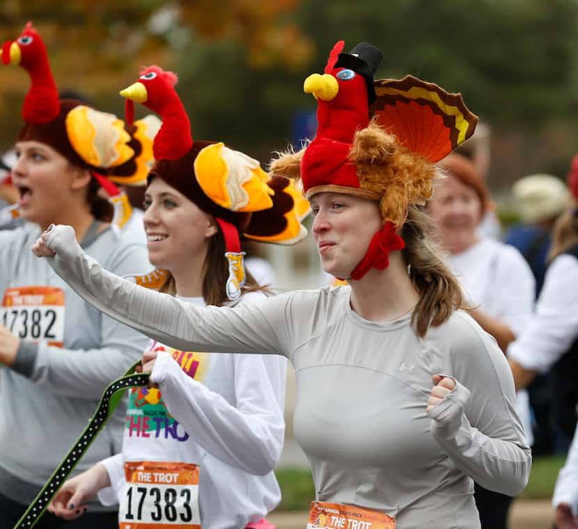 Lizzie Welch dances across the 5K finish line at the Dallas YMCA Turkey Trot in downtown...