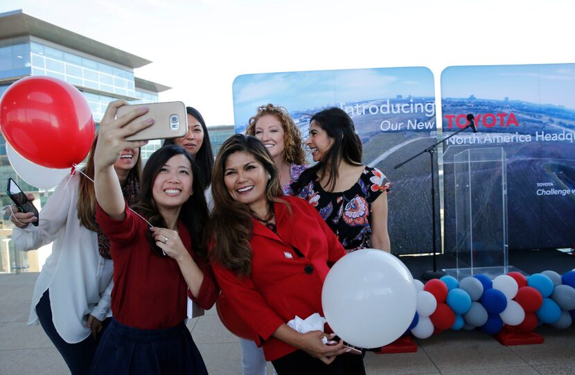 Ann Bui (bottom left), Lenie Tumminia (bottom right) take a group photo before an...