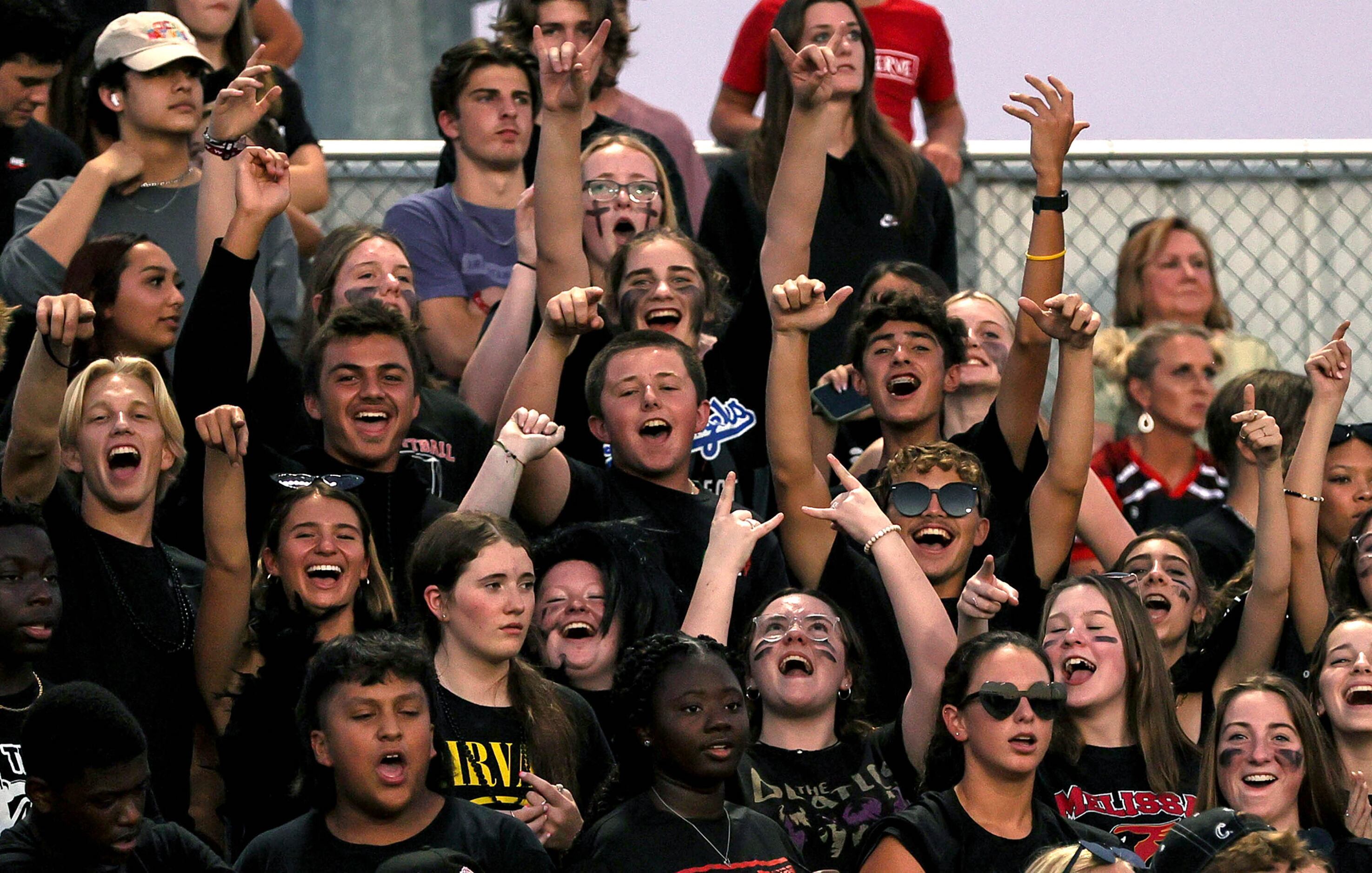 The Melissa students cheer on their Cardinals against Argyle in a high school football game...