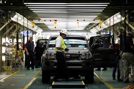 A Toyota Tacoma truck waits to come off the final inspection line at the Toyota's plant in...