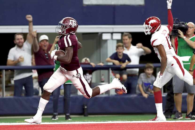 ARLINGTON, TX - SEPTEMBER 29:  Jashaun Corbin #7 of the Texas A&M Aggies runs the ball past...