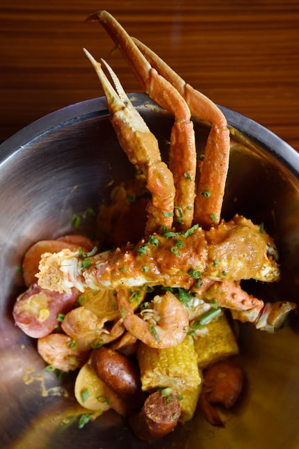 Alaskan king crab smothered in Cajun garlic butter comes with potatoes, sausage and corn.