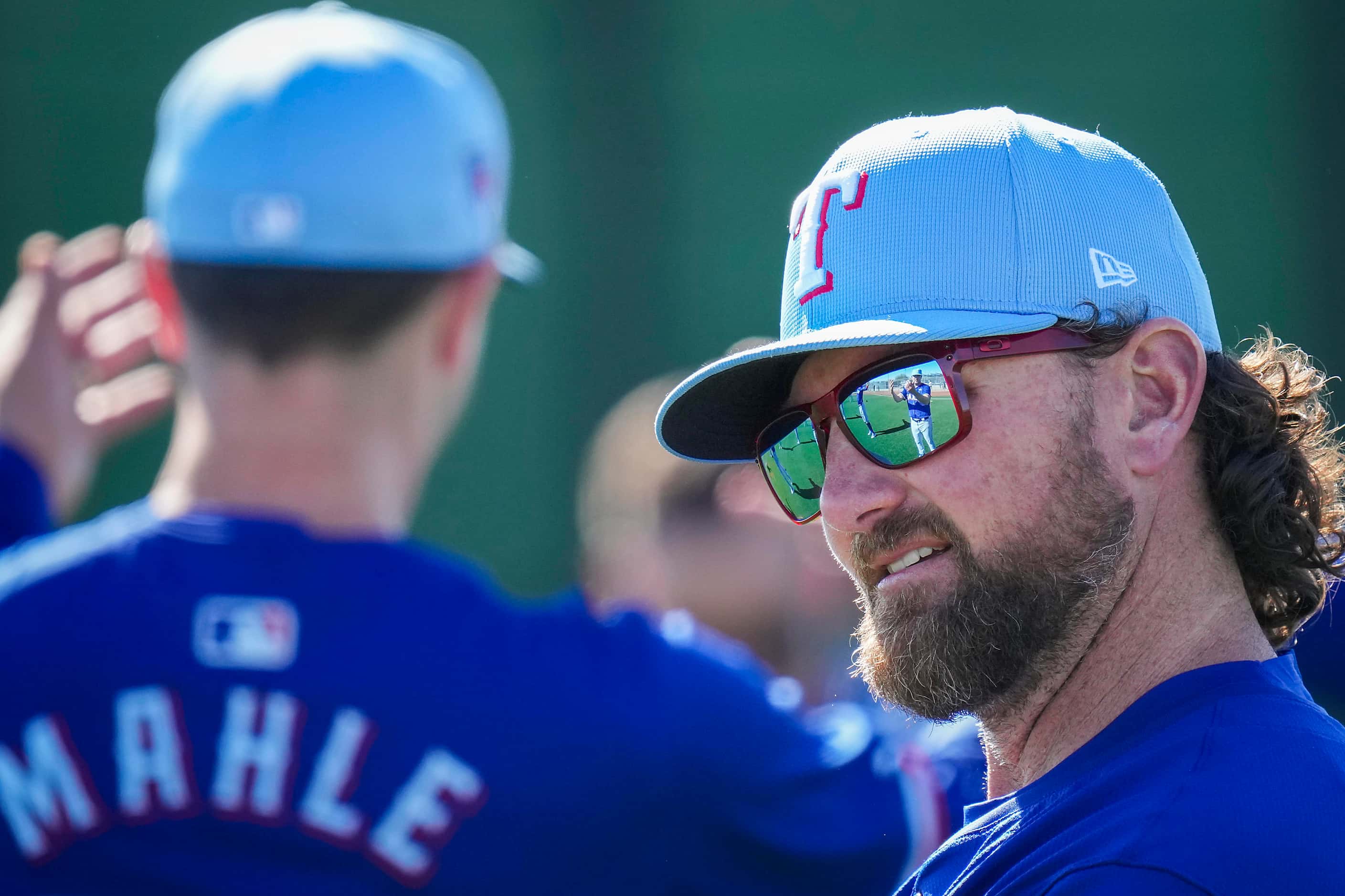 Texas Rangers pitcher Kirby Yates stretches with teammates during the first Spring Training...