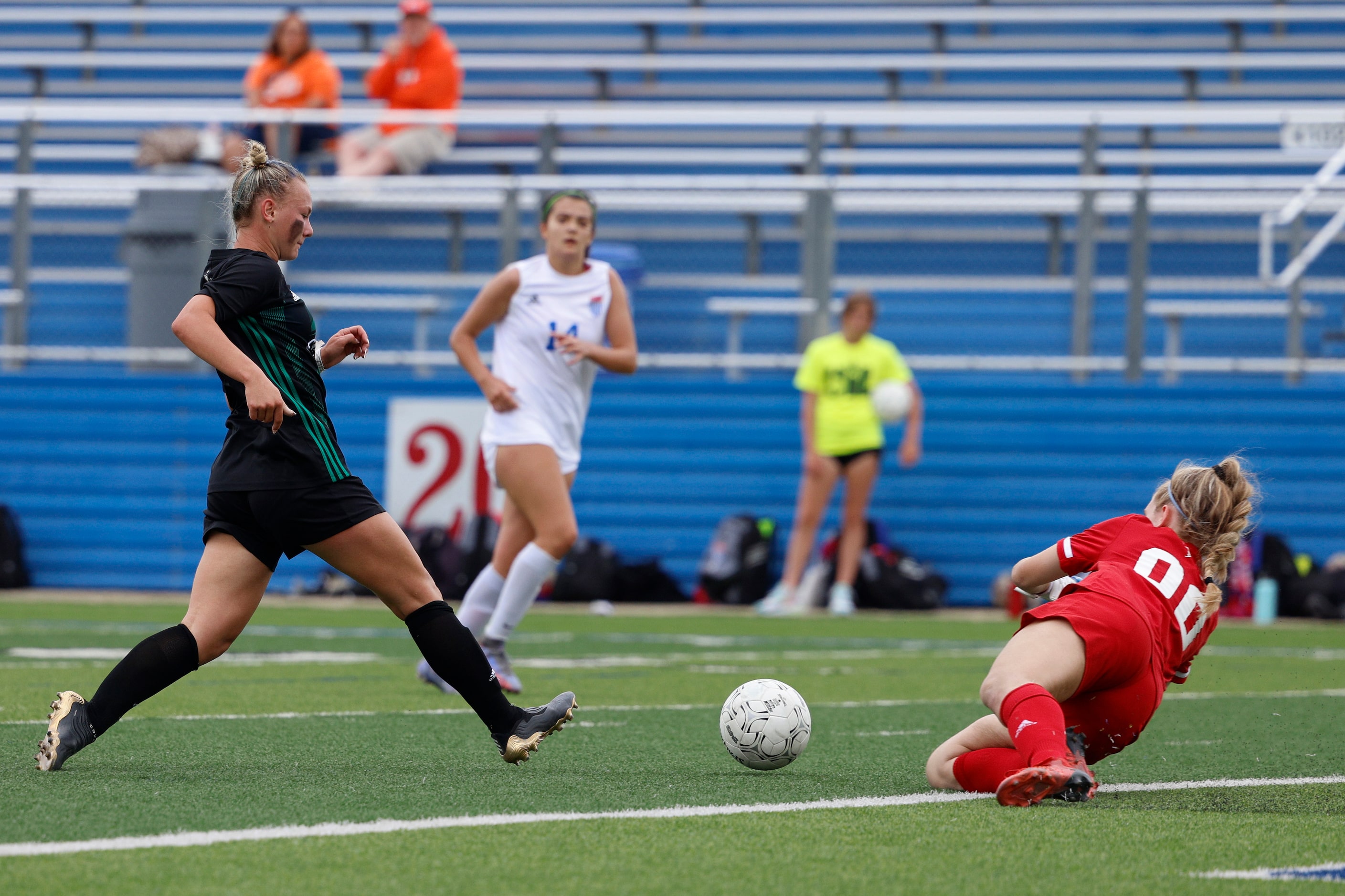 Austin Westlake goalkeeper Emma Payton (00) dives for the ball ahead of Southlake Carroll...