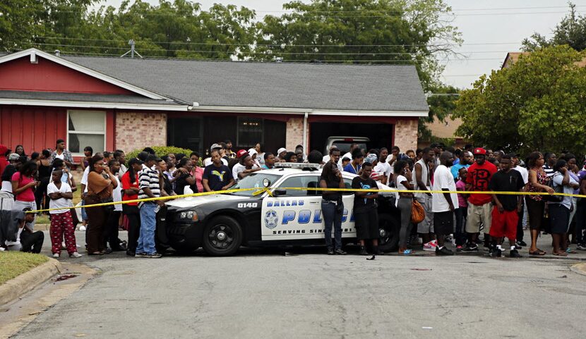 A crowd of about 200 Oak Cliff residents gathered outside of the homicide scene.