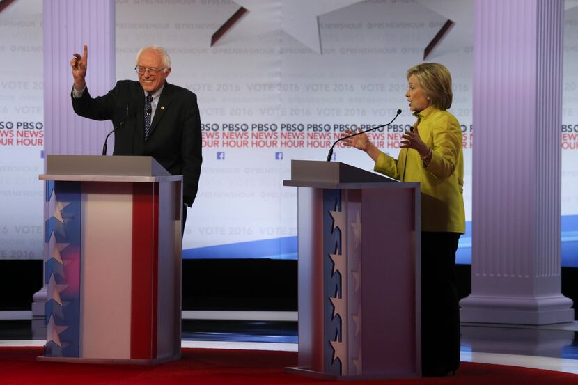 Sen. Bernie Sanders of Vermont signals to moderators as Hillary Clinton speaks during their...