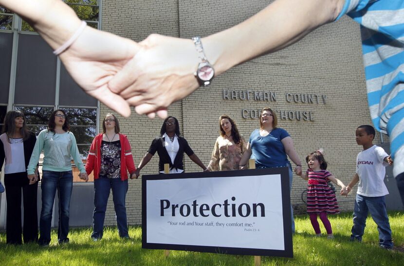 Kaufman County residents pray during a prayer walk around the Kaufman County Courthouse in...