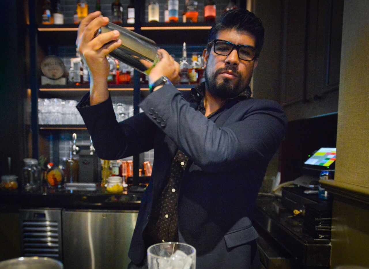 Bartender Alfredo Sanchez behind the bar at Outlaw Taproom.