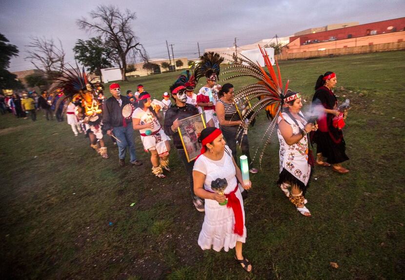 A procession to honor  the dead walked through the Vickery Meadow neighborhood in northeast...