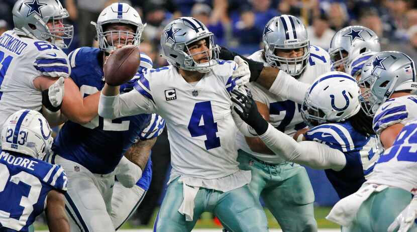 Dallas Cowboys quarterback Dak Prescott (4) tries to throw a pass under heavy pressure in th...