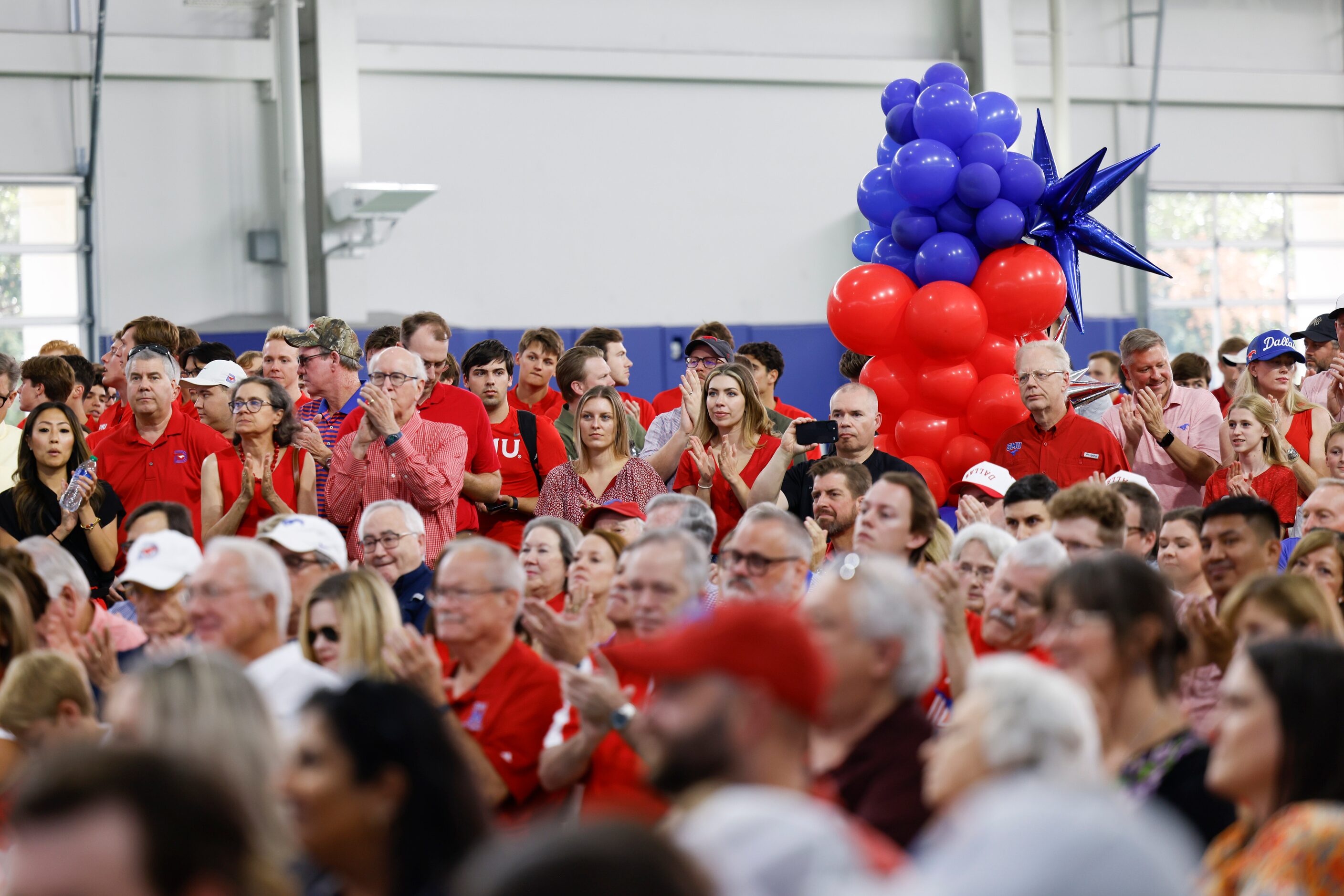 Attending crowd cheer upon the announcement of SMU’s move to NCAA Atlantic Coast Conference...