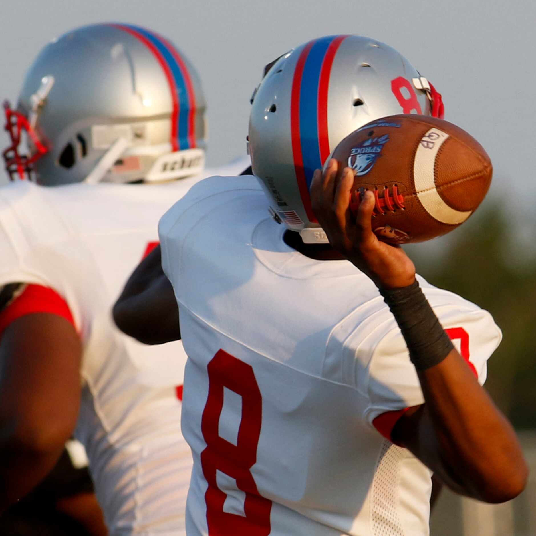 Spruce quarterback Damethis Davis (8) launches a pass downfield during first half action...