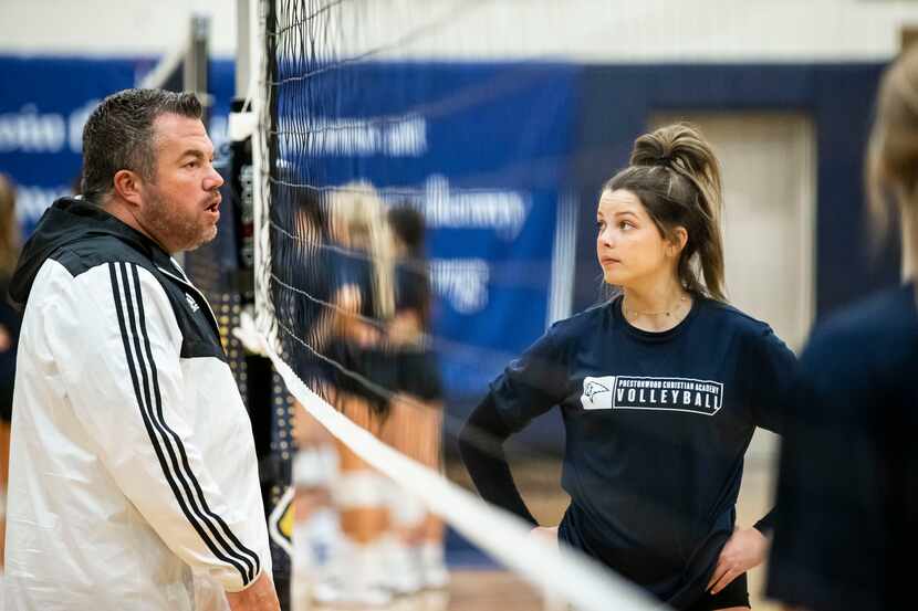 Nicole Foster listens to coach Ryan Mitchell’s, left, instructions during a volleyball...