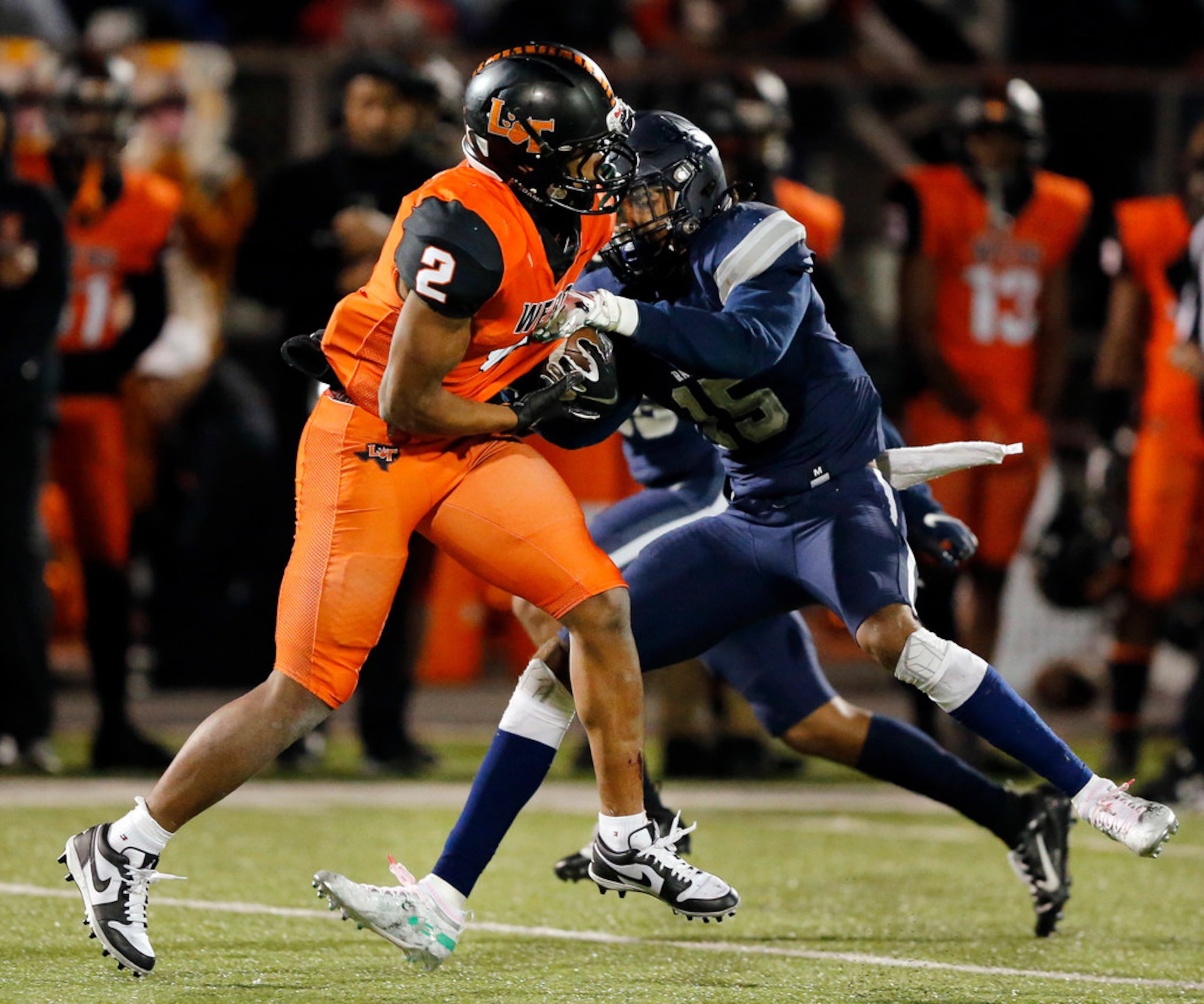 Frisco Lone Star linebacker Toren Pittman (15) tries to strip the ball from Lancaster...