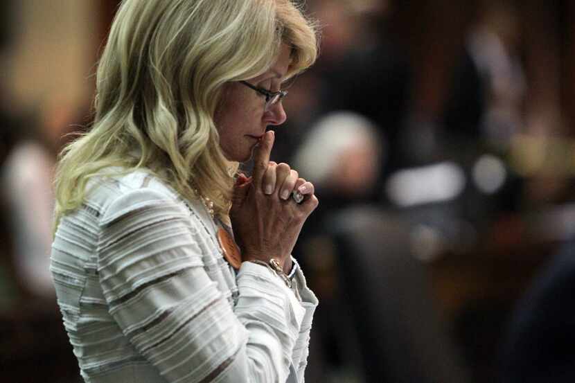 State Sen. Wendy Davis spent a quiet moment after her filibuster was halted June 25, 2013 —...