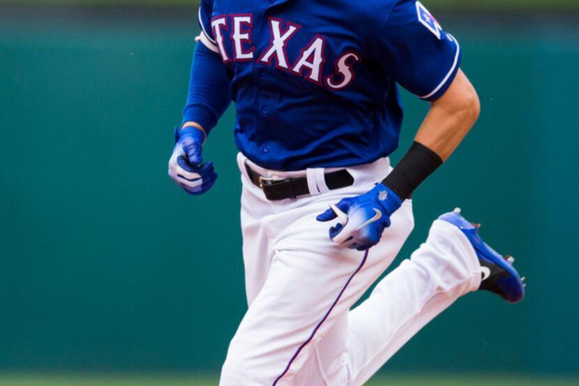 Texas Rangers center fielder Drew Robinson (18) runs the bases after hitting a home run...