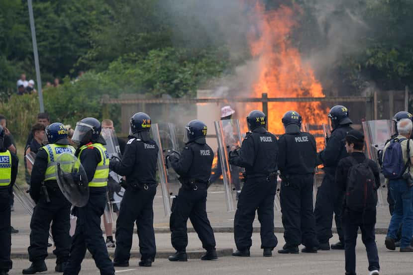 Police officers blocked protesters at an anti-immigration demonstration outside the Holiday...
