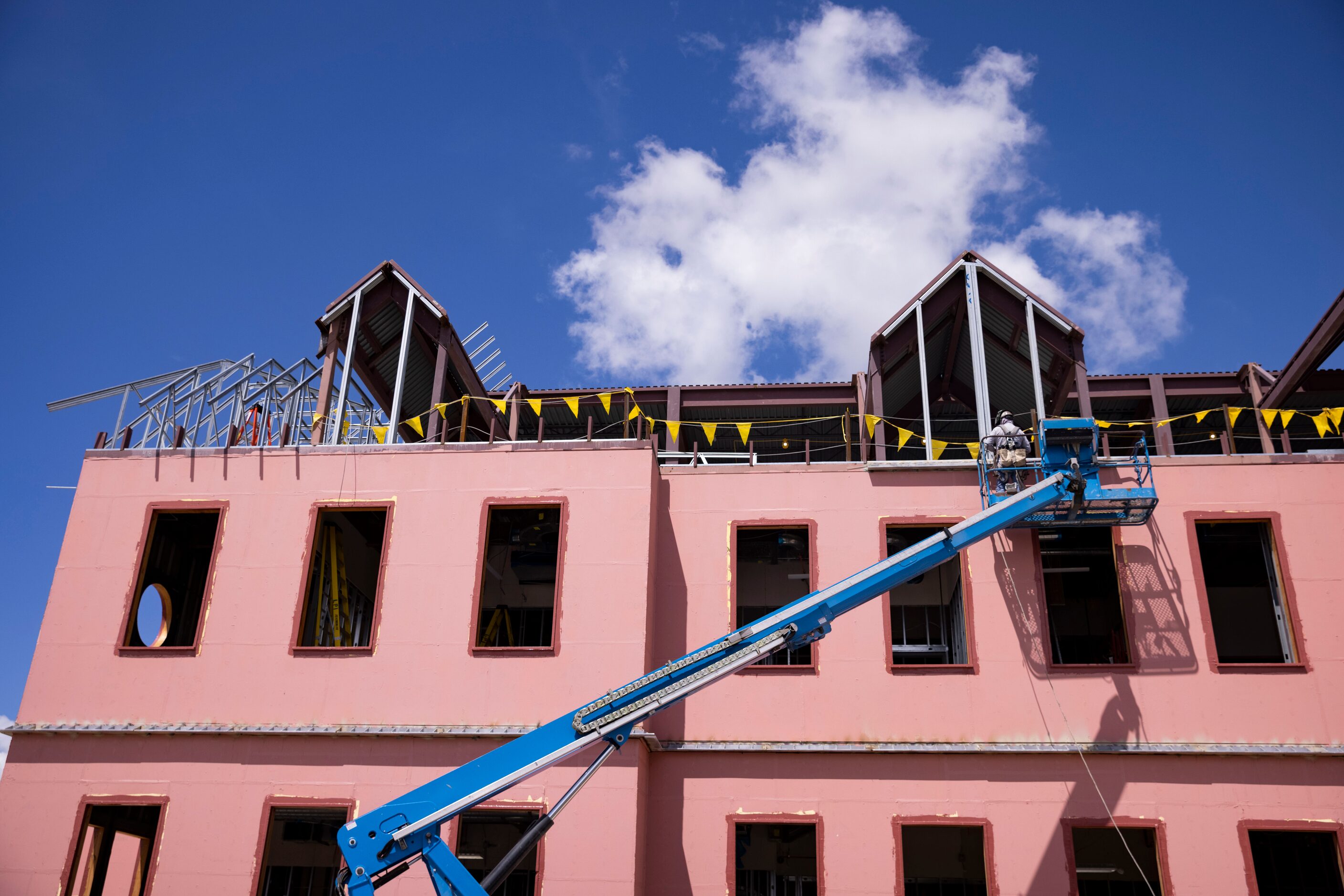 A construction worker works on the City Hall Annex.