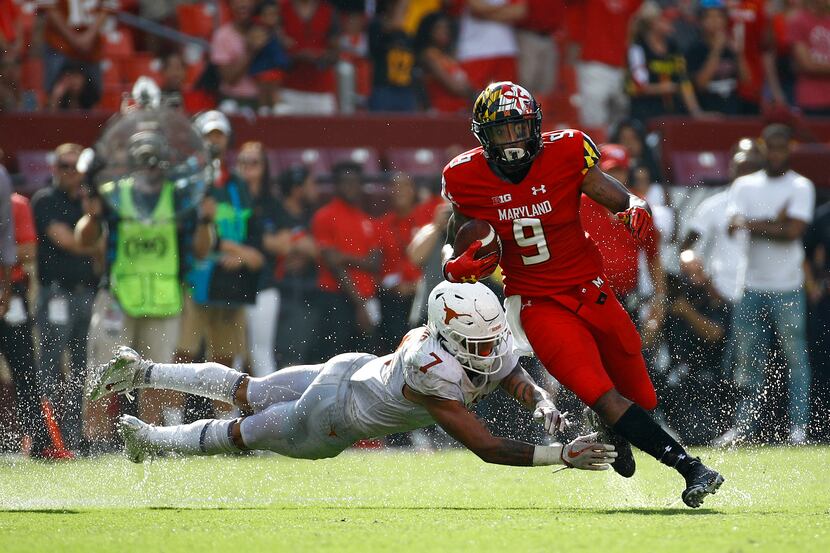 Maryland wide receiver Jahrvis Davenport, right, rushes past Texas defensive back Caden...