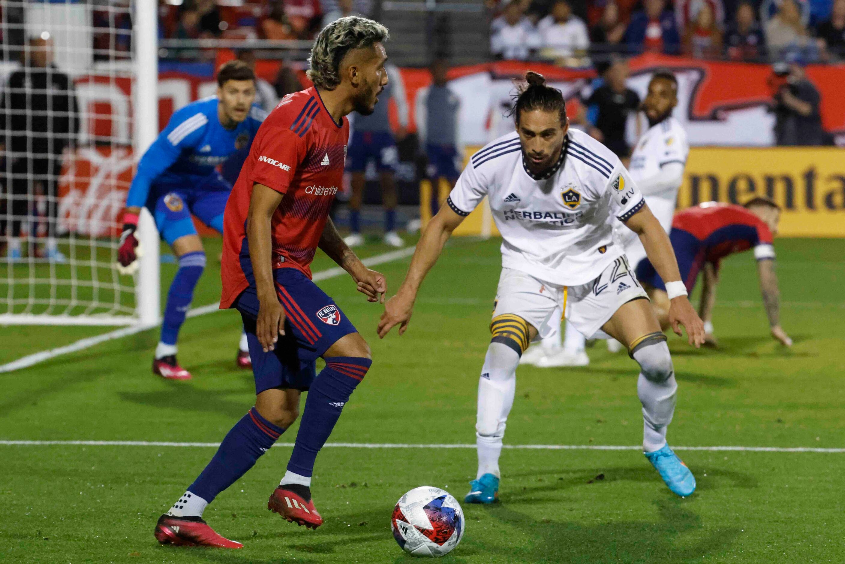 FC Dallas forward Jesús Ferreira (left) looks to pass past Los Angeles Galaxy defender...