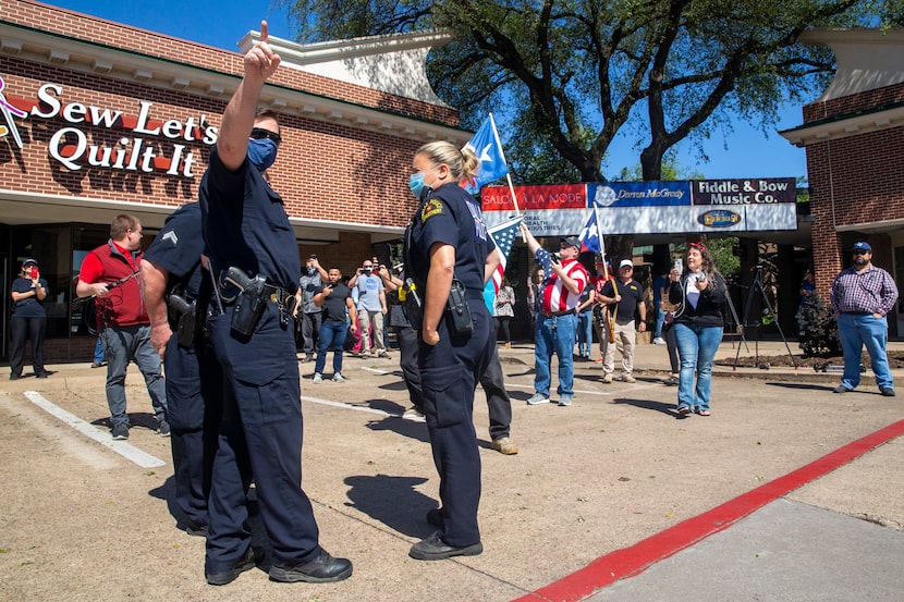 Dallas Police officers announce their presence to supporters while paying a visit to Shelley...