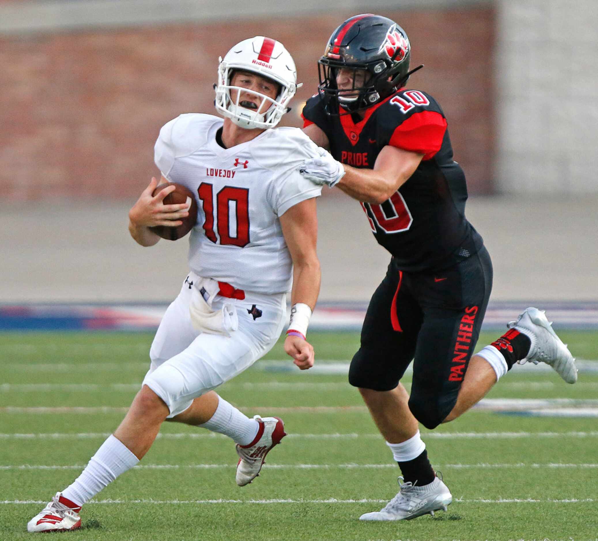 Lovejoy High School quarterback Ralph Rucker (10) is caught by Colleyville Heritage High...