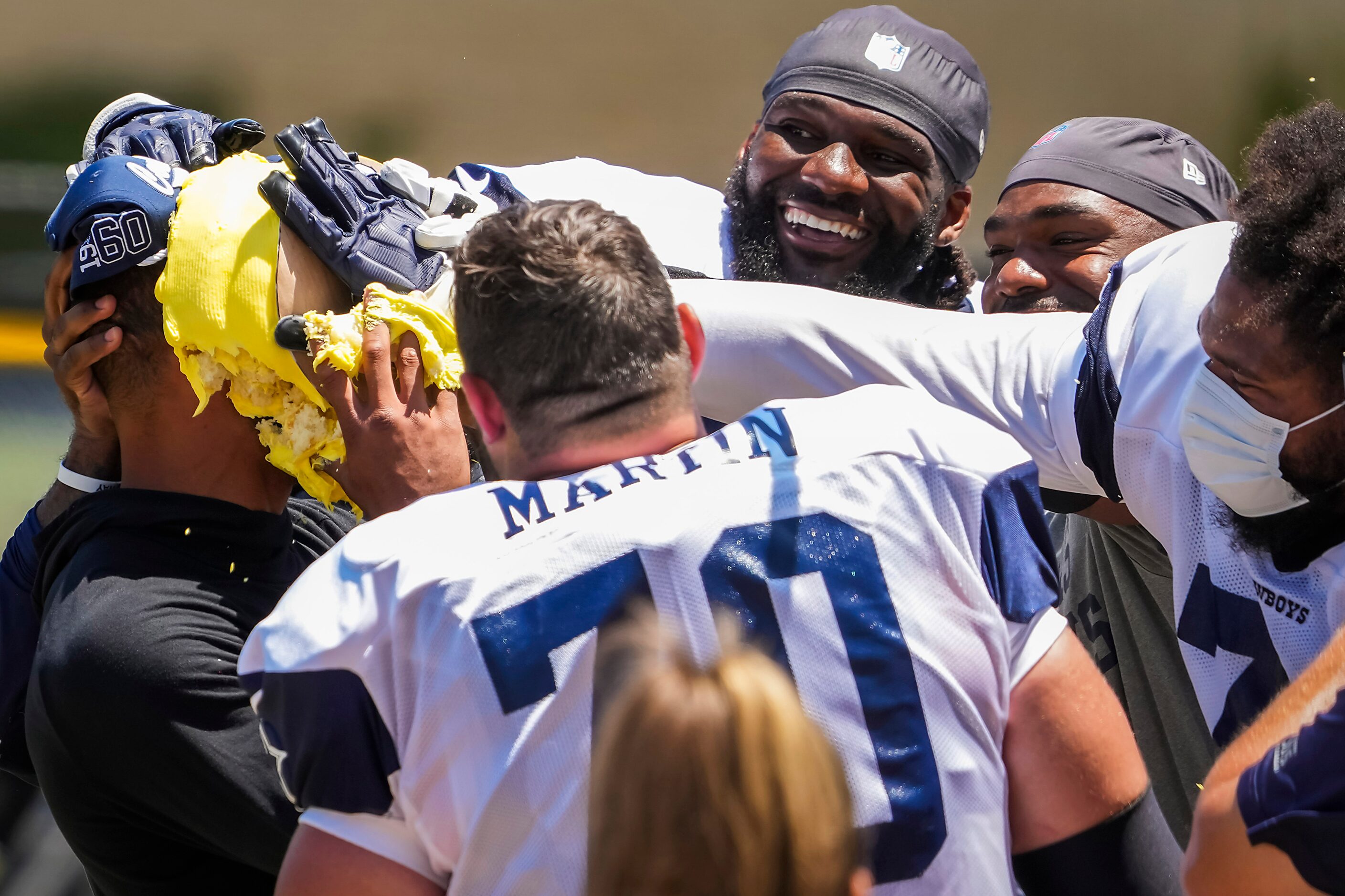 Dallas Cowboys quarterback Dak Prescott gets a cake to the face from his teammates,...