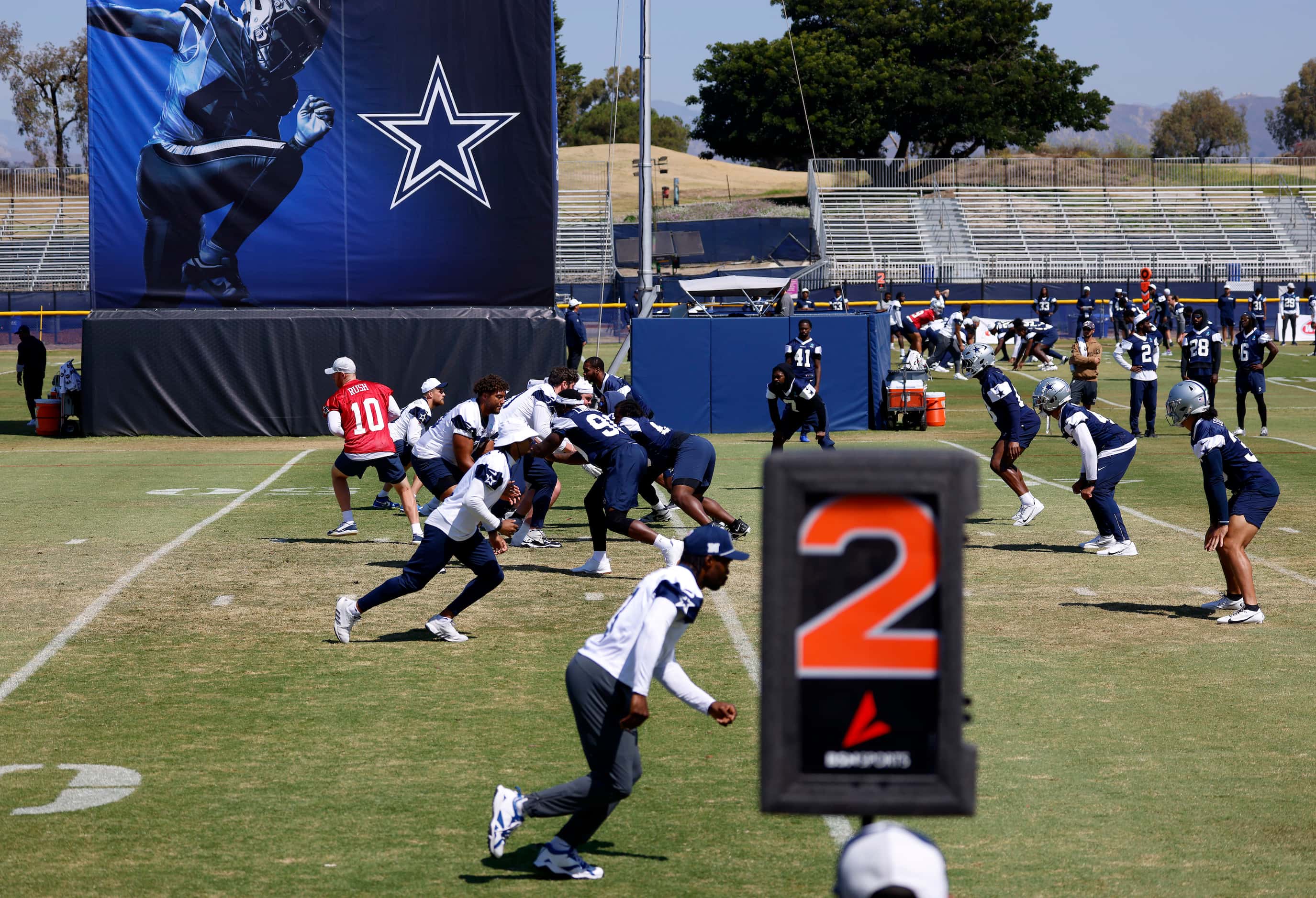 The Dallas Cowboys offense runs a play during a mock game in Oxnard, California, August 1,...