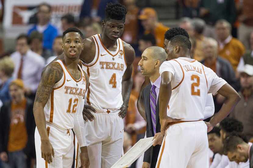 Texas head coach Shaka Smart talks to his players during an NCAA college basketball game...