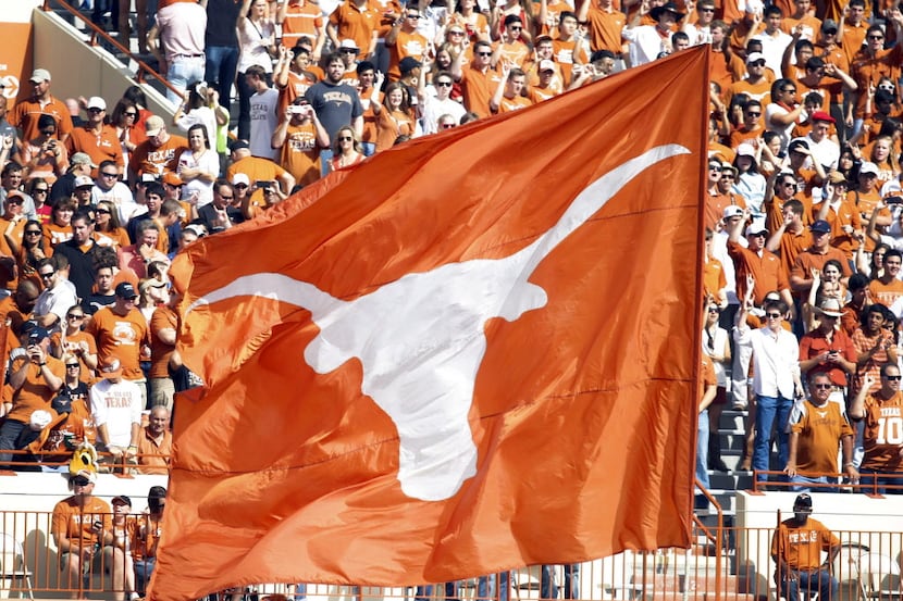 FILE — Texas Longhorns cheerleaders wave a flag after a touchdown against the Iowa State...