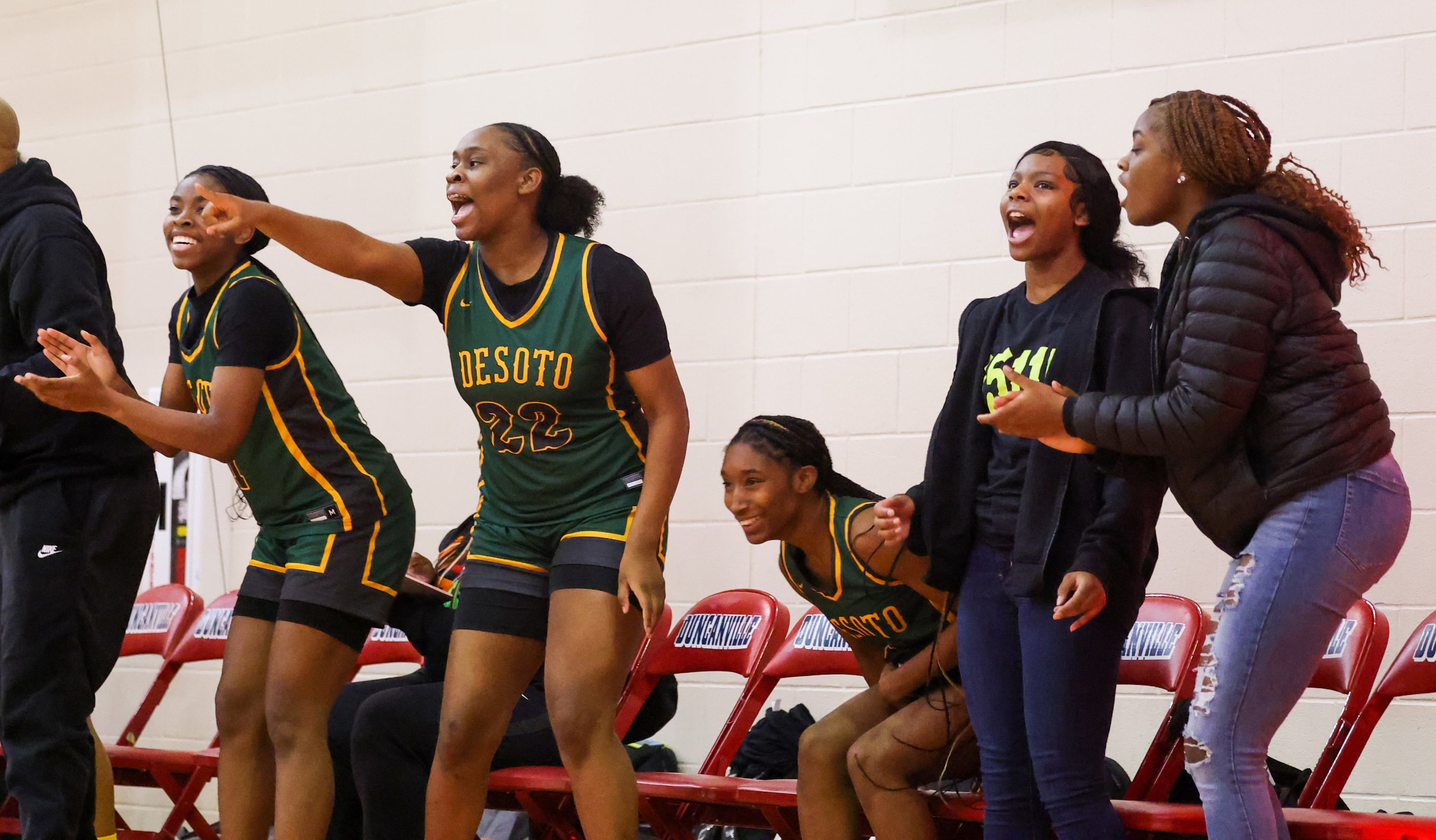 DeSoto girls basketball players cheer for a two-point shot that tied up the score in the in...