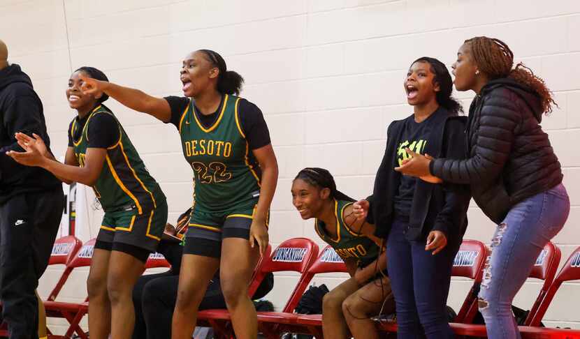 DeSoto girls basketball players cheer for a two-point shot that tied up the score in the in...