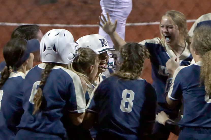 Keller's Hailey Jones (center) shares her elation with her teammates as she is mobbed at...