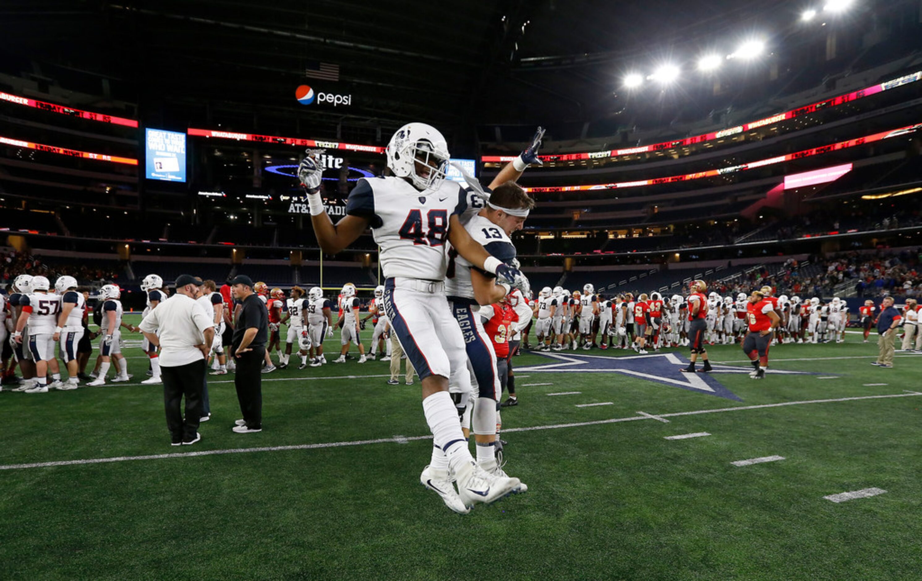 Allen's Courtenay Moore (48) and Ryan Angeloni (13) celebrate a 28-14 win over South Grand...