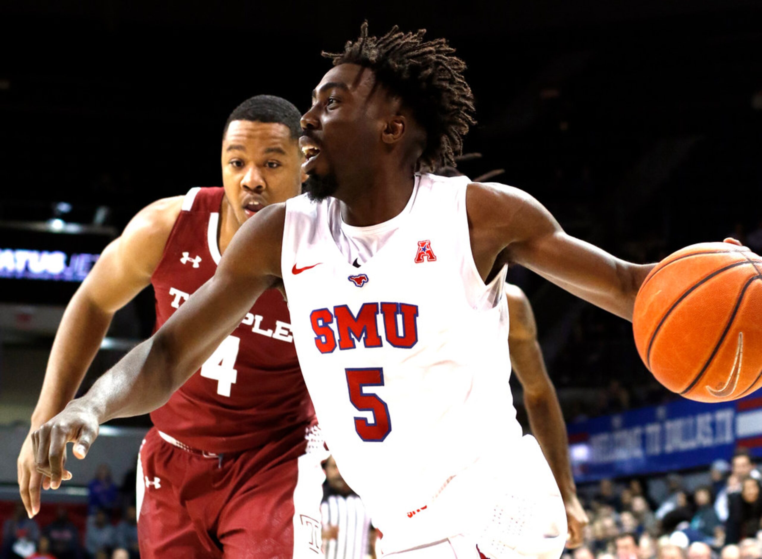 SMU guard Emmanuel Bandoumel (5) drives the baseline past the defense of Temple forward J.P....