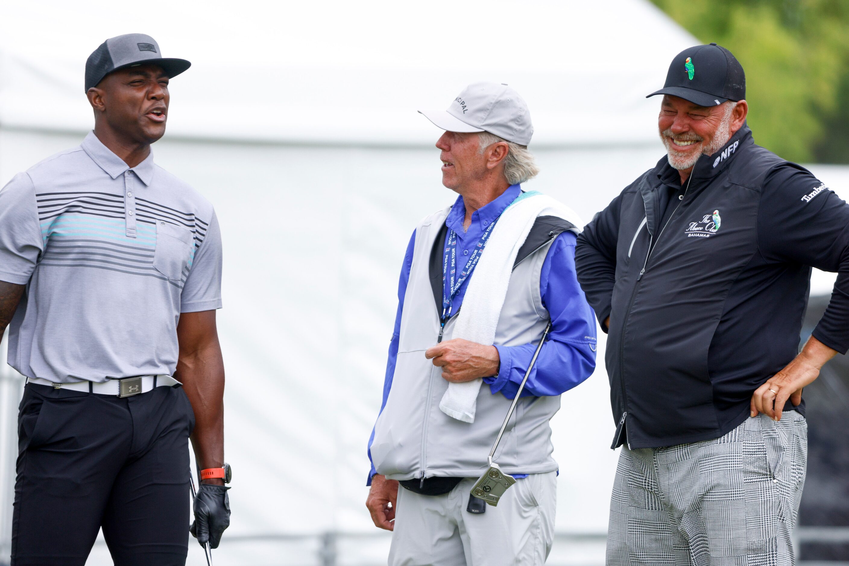 Former Dallas Cowboys player DeMarcus Ware (left) speaks with professional golfer Darren...