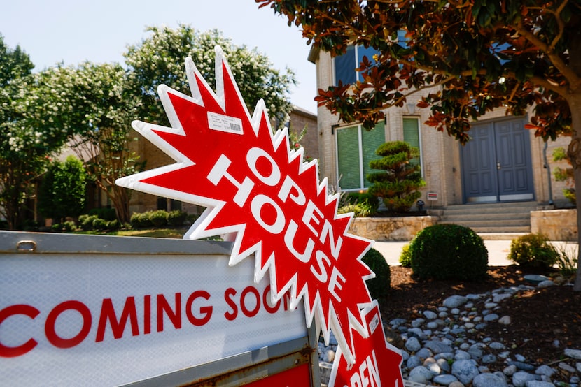 An open house sign beckons buyers outside of a home in Plano. 