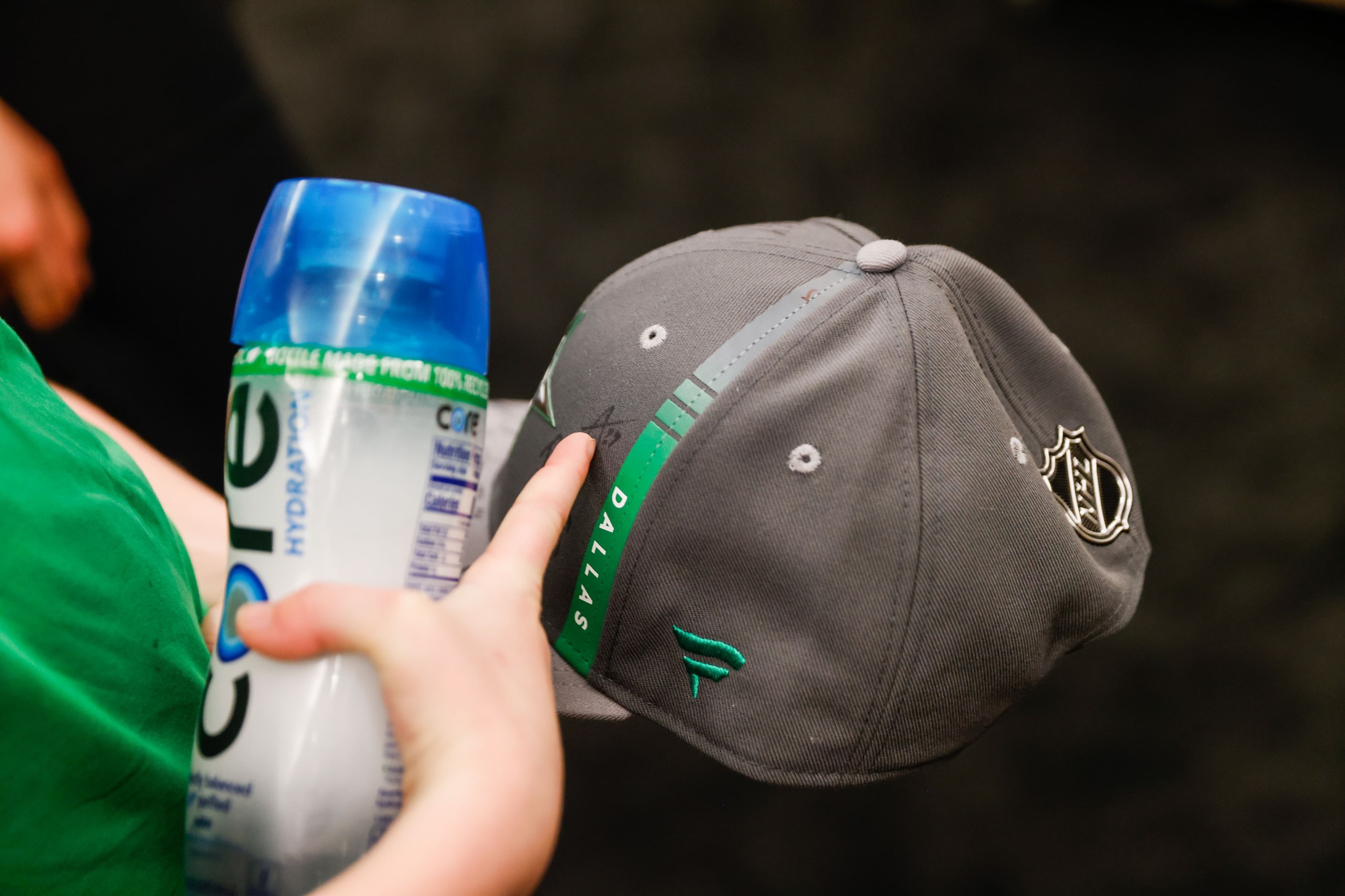 Max Hinojosa, 9, checks his cap signed by the Dallas Stars players at the American Airlines...