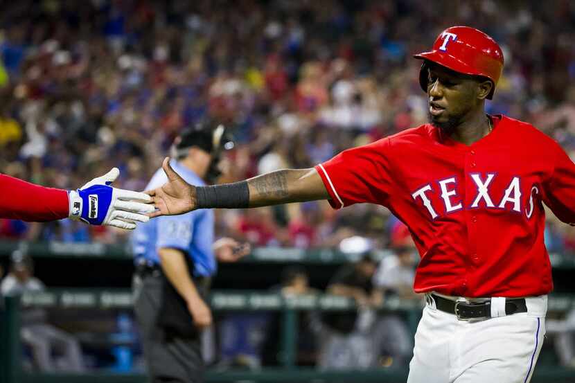 Texas Rangers second baseman Jurickson Profar gets a hand from designated hitter Prince...