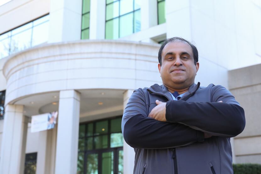 Manu Kurian stands outside the Bank of America building in Addison. Kurian holds the highest...