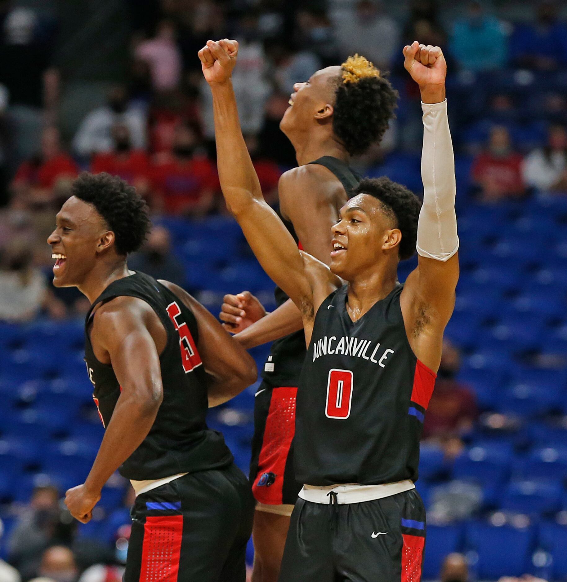 Duncanville Zhuric Phelps #0 celebrates with teammates. UIL boys Class 6A basketball state...