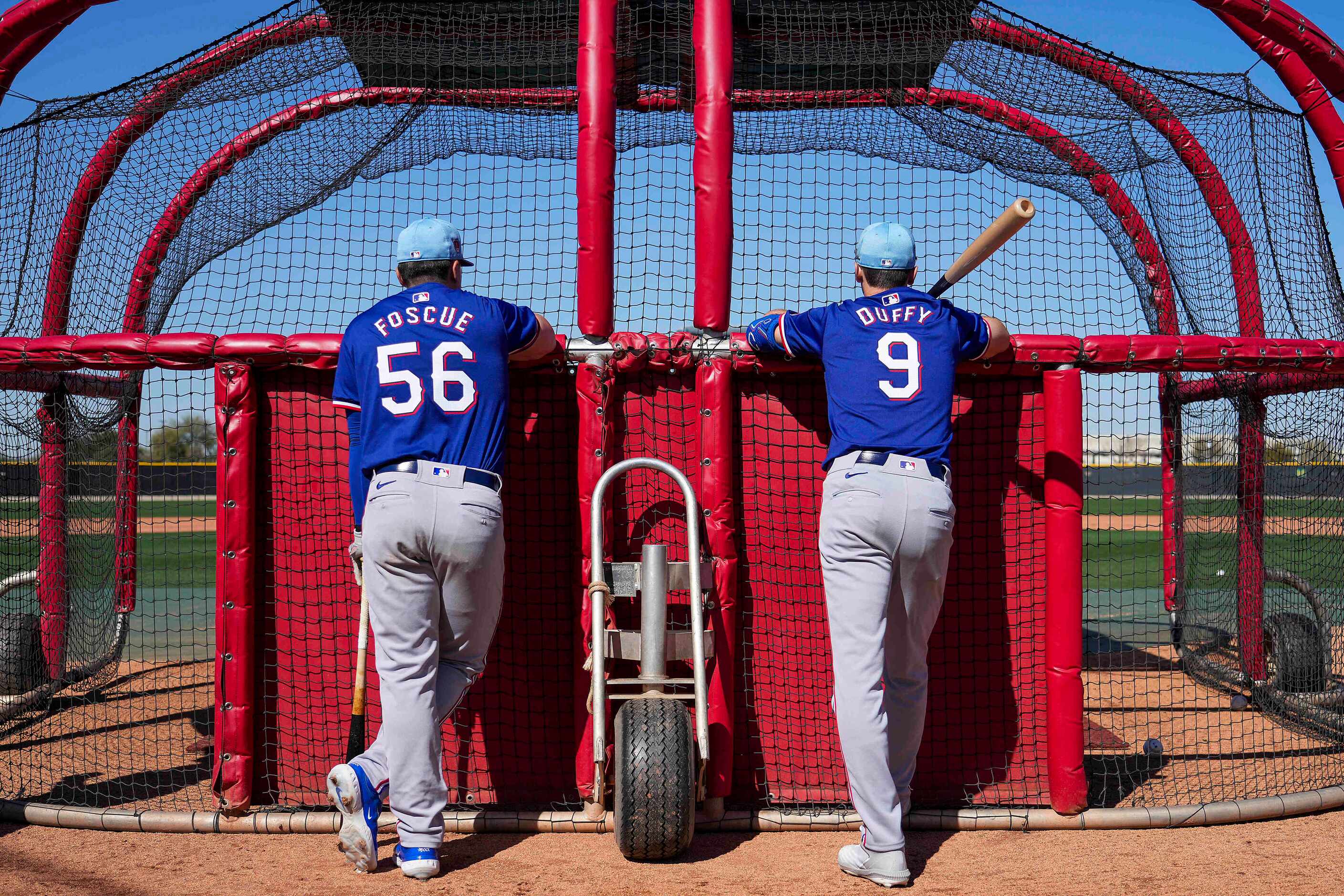 Texas Rangers infielders Justin Foscue and Matt Duffy wait their turn for batting practice...
