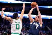 Dallas Mavericks guard Luka Doncic (77) puts up a jumper over Boston Celtics forward Jayson...