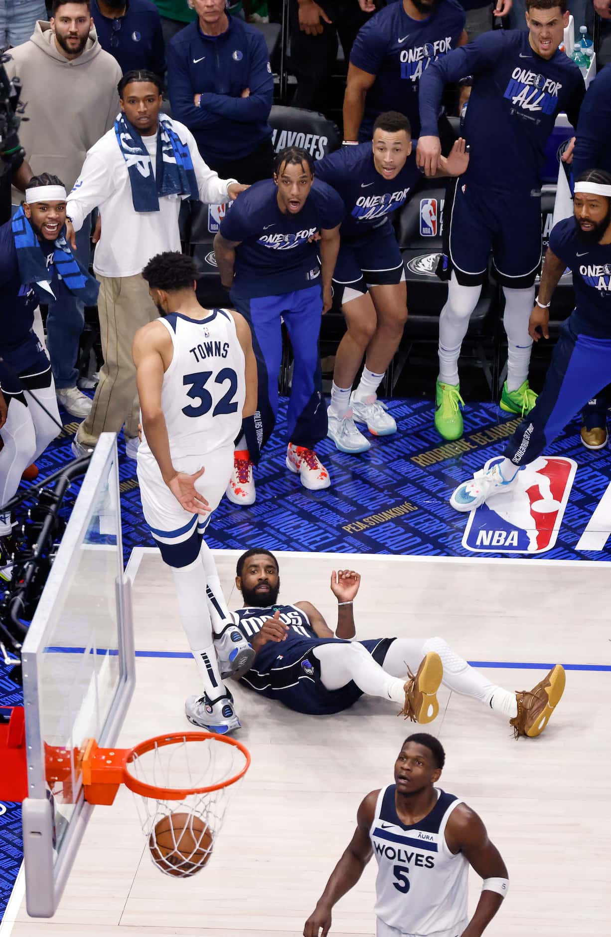 Dallas Mavericks guard Kyrie Irving (11) watches his contested shot fall through the net...