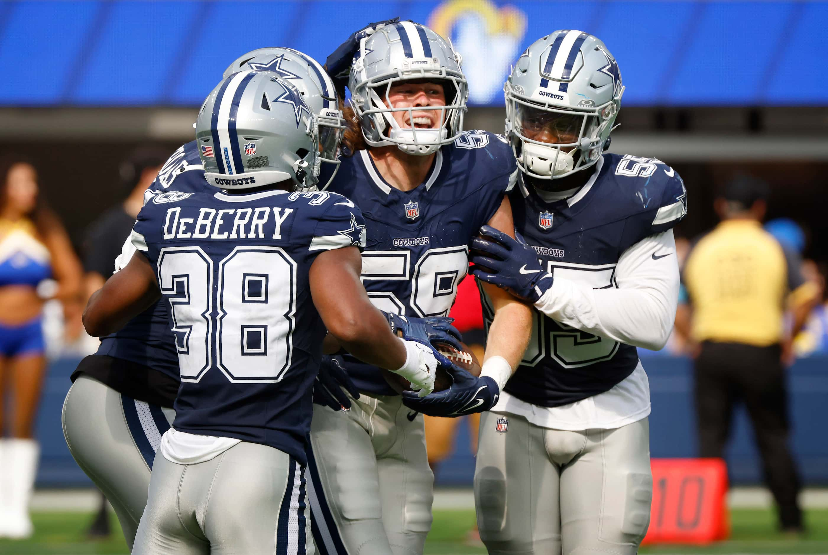 Dallas Cowboys linebacker Brock Mogensen (59) is congratulated by teammates after...